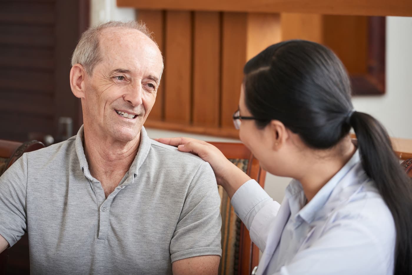 A care professional offering reassuring support to a client